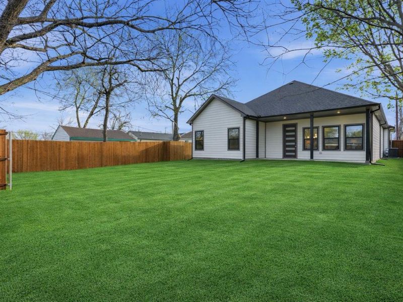 Rear view of property featuring a fenced backyard, a patio, and a shingled roof Rear view of property featuring a fenced backyard, a patio, and a shingled roof