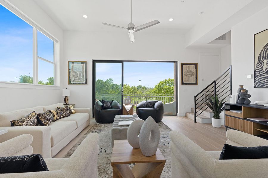 Living room featuring a ceiling fan, wood finished floors, plenty of natural light, stairs, and recessed lighting