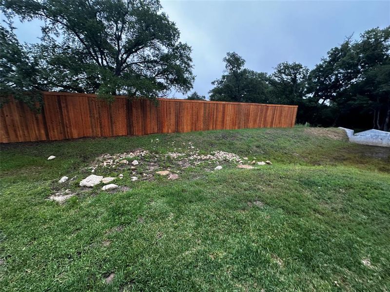 8-foot wooden privacy fence spans the rear perimeter.