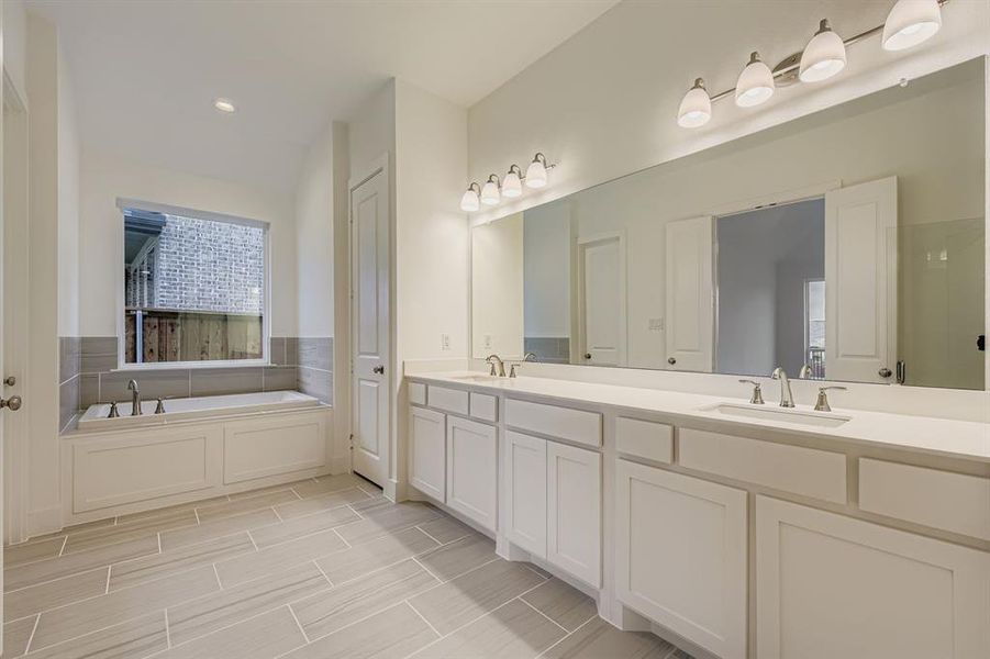 Main bathroom with double vanity, a garden tub, and recessed lighting Main bathroom with double vanity, a garden tub, and recessed lighting