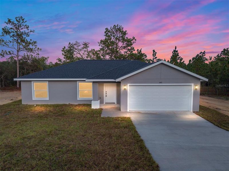Front exterior of a new home in , Dunnellon, FL, highlighting curb appeal (Image 1).