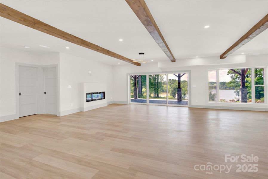 Open great room has gas fireplace and sliding doors to tiled patio overlooking LKN Open great room has gas fireplace and sliding doors to tiled patio overlooking LKN