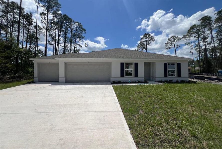 Front exterior of a new home in Palm Coast: Value Collection, Palm Coast, FL, highlighting curb appeal (Image 1).