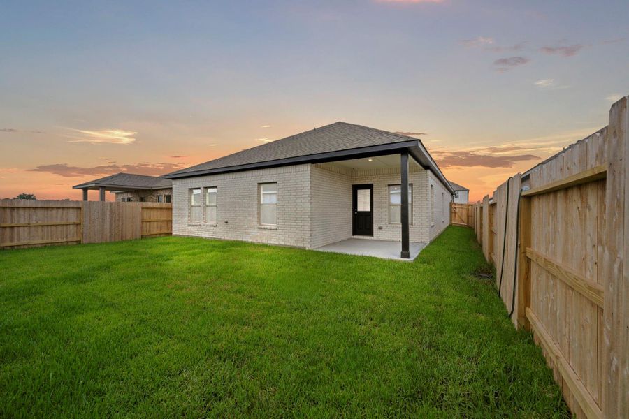 Exterior details and patio area of a home in Windrose Green, Angleton (Image 4).