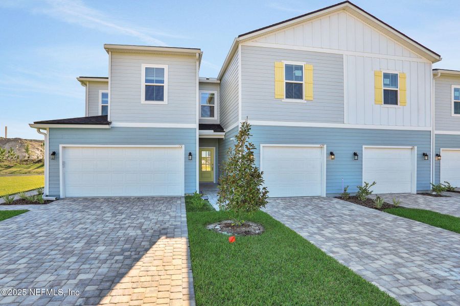 Front exterior of a new home in Brook Forest - Townhomes, St. Augustine, FL, highlighting curb appeal (Image 1).