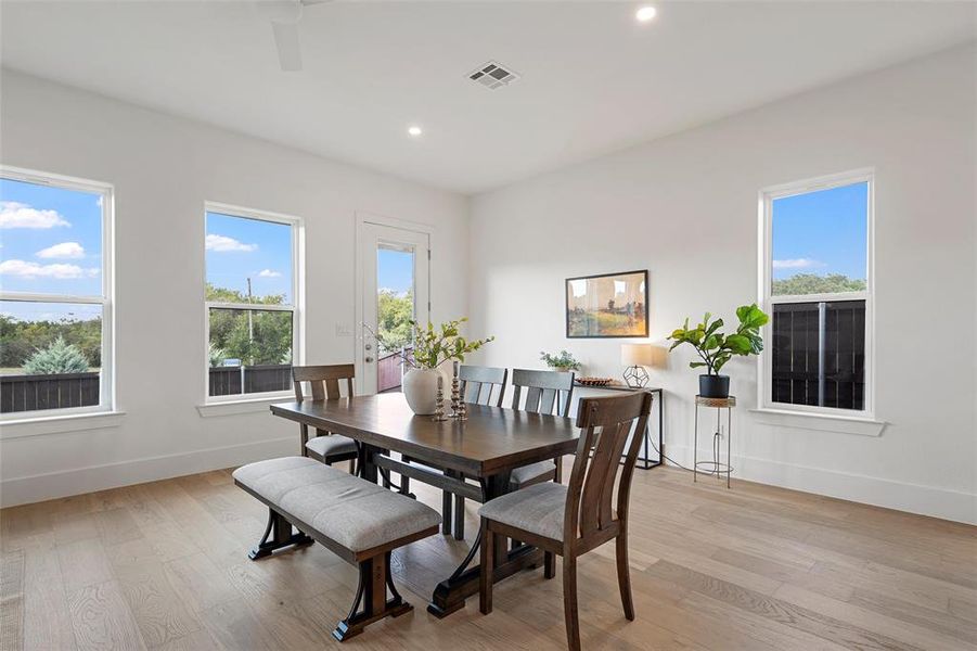 Dining space with recessed lighting and light wood-style flooring Dining space with recessed lighting and light wood-style flooring