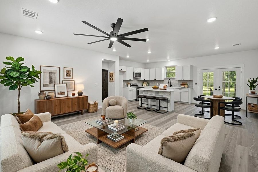 An open floorplan seamlessly connects the living area, kitchen, and dining space, perfect for entertaining. An open floorplan seamlessly connects the living area, kitchen, and dining space, perfect for entertaining.