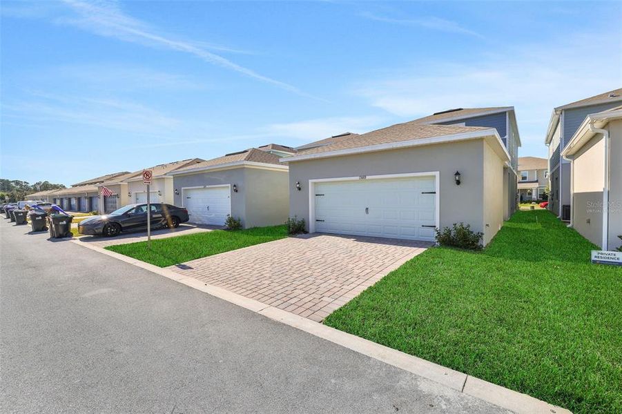 Front exterior of a new home in Serenade at Ovation, Winter Garden, FL, highlighting curb appeal (Image 23). Front exterior of a new home in Serenade at Ovation, Winter Garden, FL, highlighting curb appeal (Image 23).