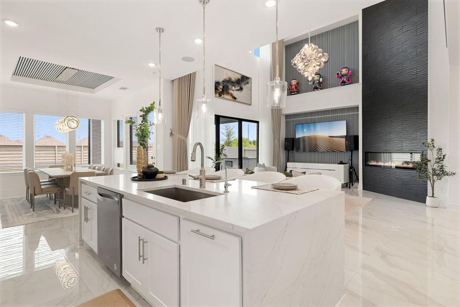 Sleek kitchen featuring a large island, modern finishes, and abundant workspace.