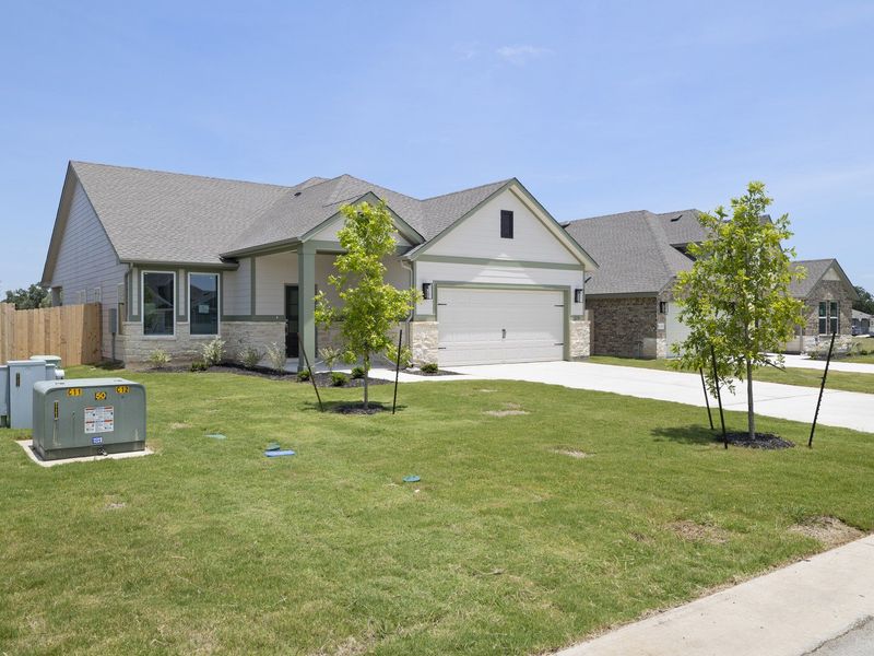 Front exterior of a new home in Grande Estates, Bertram, TX, highlighting curb appeal (Image 2). Front exterior of a new home in Grande Estates, Bertram, TX, highlighting curb appeal (Image 2).