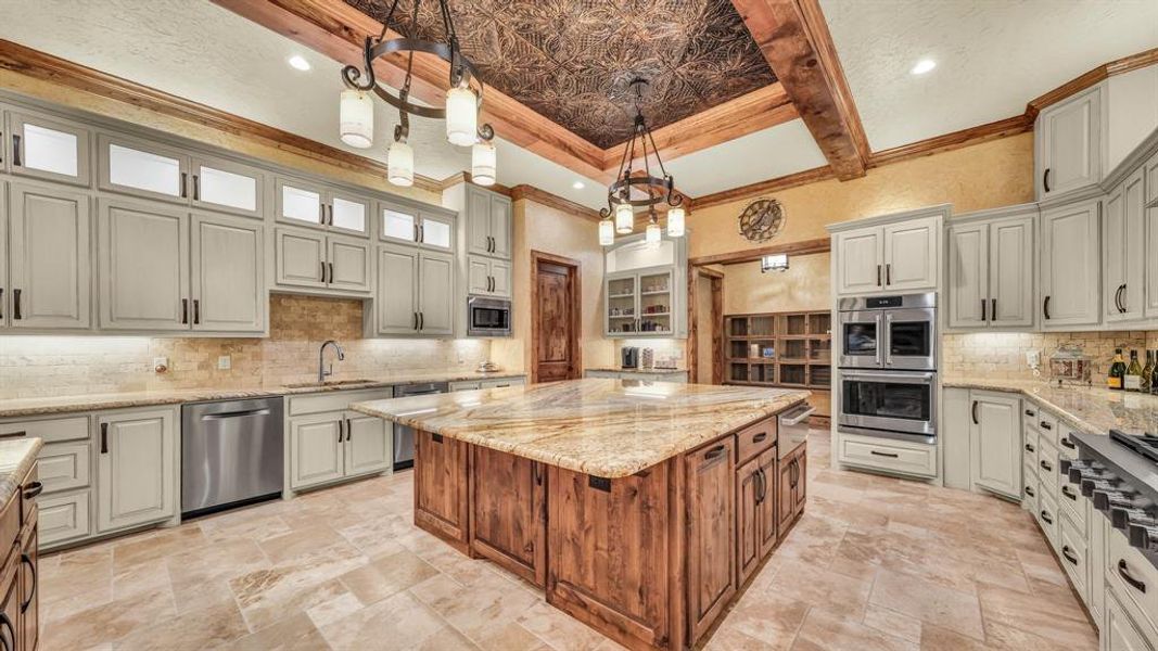 Expansive workspace with abundant storage, stainless steel appliances, and a professional-grade gas cooktop.