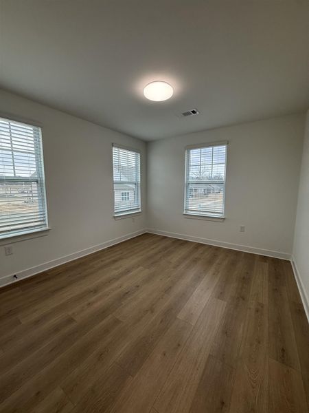 Unfurnished room featuring light wood-style flooring and healthy amount of natural light