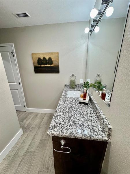 Bathroom with vanity and light wood-style floors