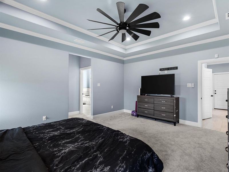 Bedroom featuring a tray ceiling, carpet floors, crown molding, a ceiling fan, and recessed lighting Bedroom featuring a tray ceiling, carpet floors, crown molding, a ceiling fan, and recessed lighting