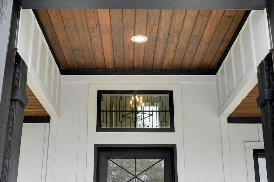 Details featuring wood ceiling and a notable chandelier