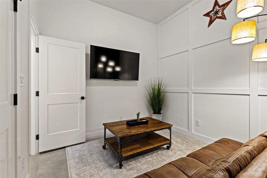 Living area with a decorative wall and concrete flooring