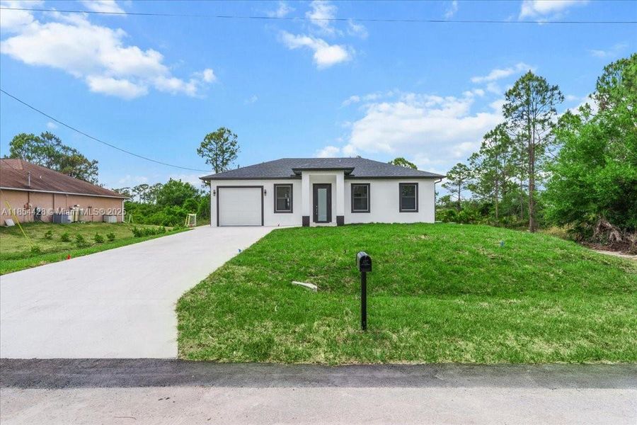 Front exterior of a new home in , Lehigh Acres, FL, highlighting curb appeal (Image 2). Front exterior of a new home in , Lehigh Acres, FL, highlighting curb appeal (Image 2).