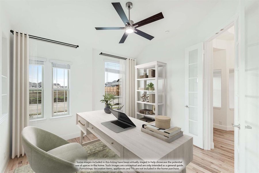 Home office with light wood desk, ceiling fan, open shelving, and hardwood floors