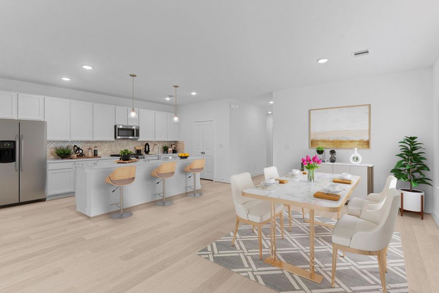 The open layout creates a bright and cheerful gathering space that connects the kitchen, dining, and family areas beautifully. Perfect for hosting family get-togethers or relaxing at home!
