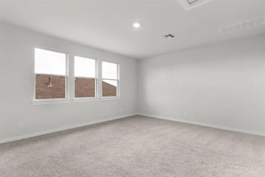 Spare room with light colored carpet and recessed lighting Spare room with light colored carpet and recessed lighting