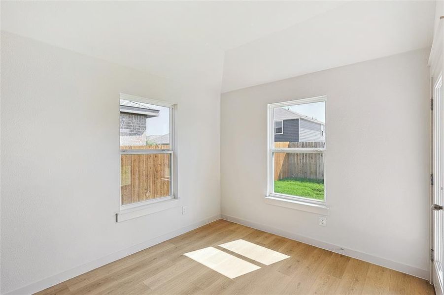 Unfurnished room with plenty of natural light and light wood-type flooring