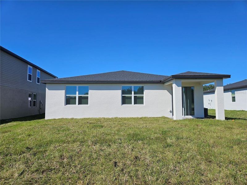 Exterior details and patio area of a home in The Reserve at Hammock Oaks - Signature Series, Lady Lake (Image 25).