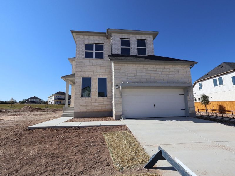 Front exterior of a new home in Cedar Brook, Leander, TX, highlighting curb appeal (Image 2).