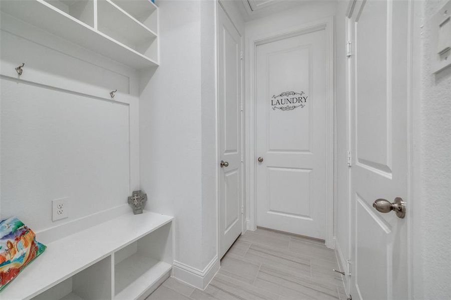 BEAUTIFUL MUDROOM AREA LEADING TO EXTRA STORAGE/CLOSET AND LAUNDRY