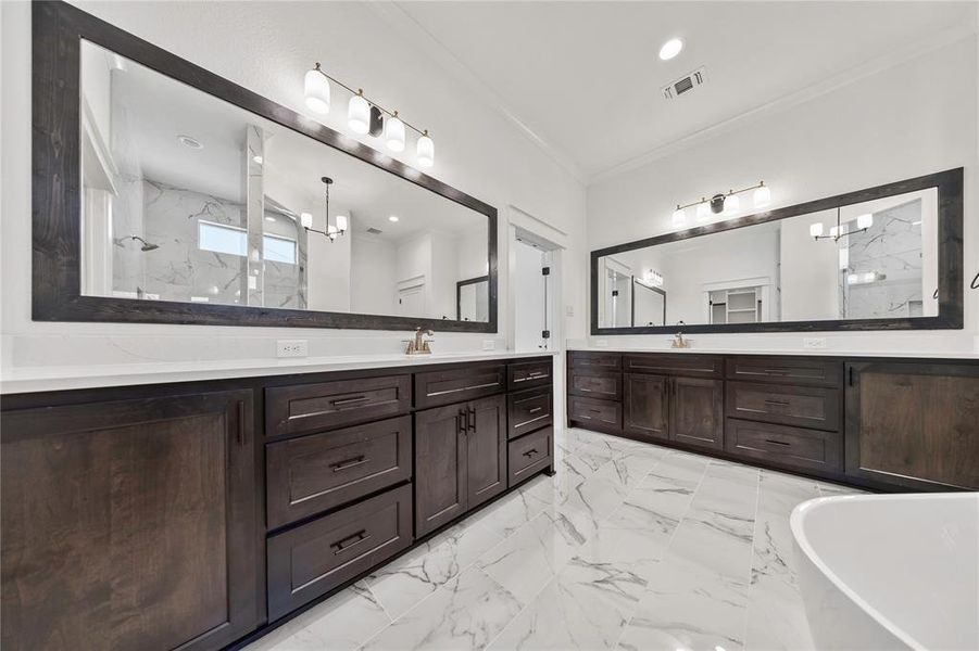 Bathroom with a soaking tub, ornamental molding, vanity, a marble finish shower, and marble finish flooring Bathroom with a soaking tub, ornamental molding, vanity, a marble finish shower, and marble finish flooring