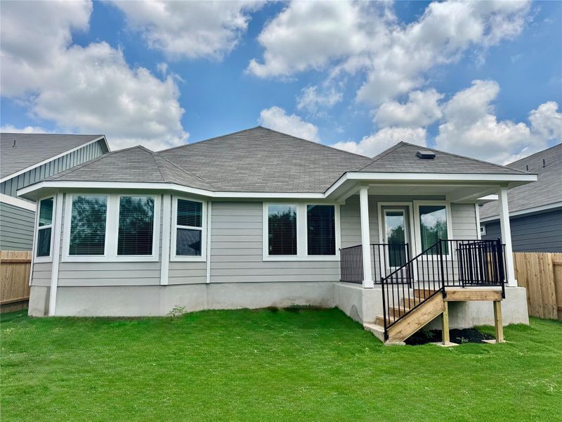 Back of property featuring a shingled roof Back of property featuring a shingled roof