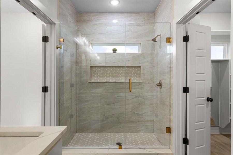 Bathroom with hardwood / wood-style flooring, vanity, and an enclosed shower