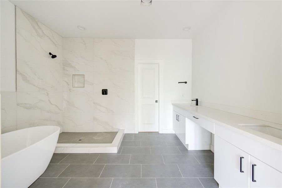 Large primary bathroom. Glass surround for the shower will be installed closer to closing