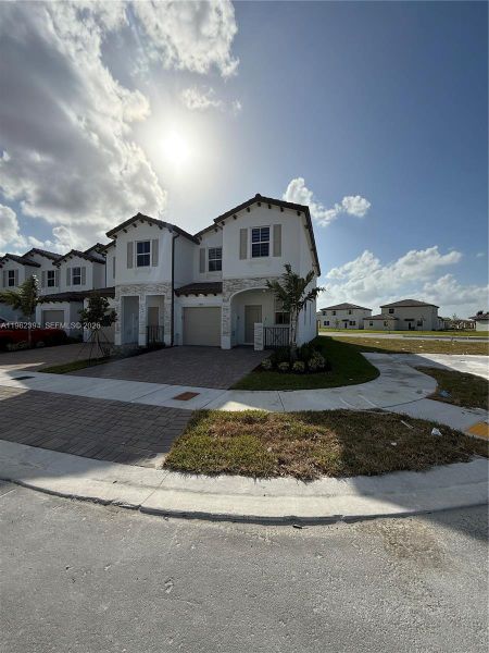 Front exterior of a new home in , Homestead, FL, highlighting curb appeal (Image 1). Front exterior of a new home in , Homestead, FL, highlighting curb appeal (Image 1).