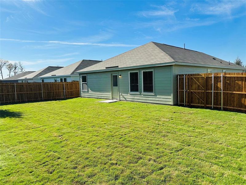 Rear view of property featuring a lawn