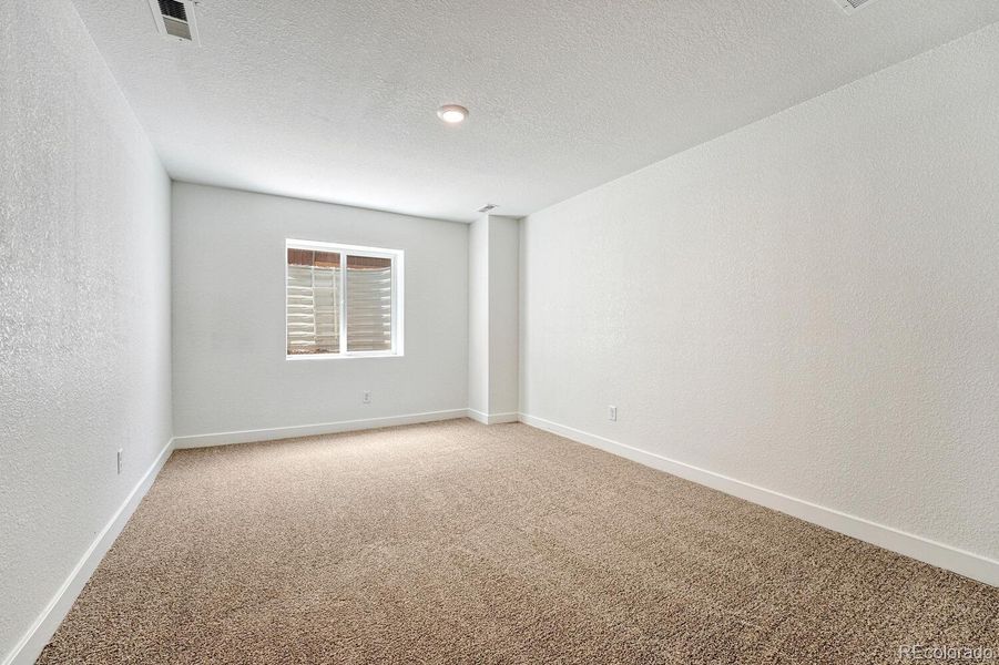 Fourth bedroom in the basement is perfect for guests or generational living.