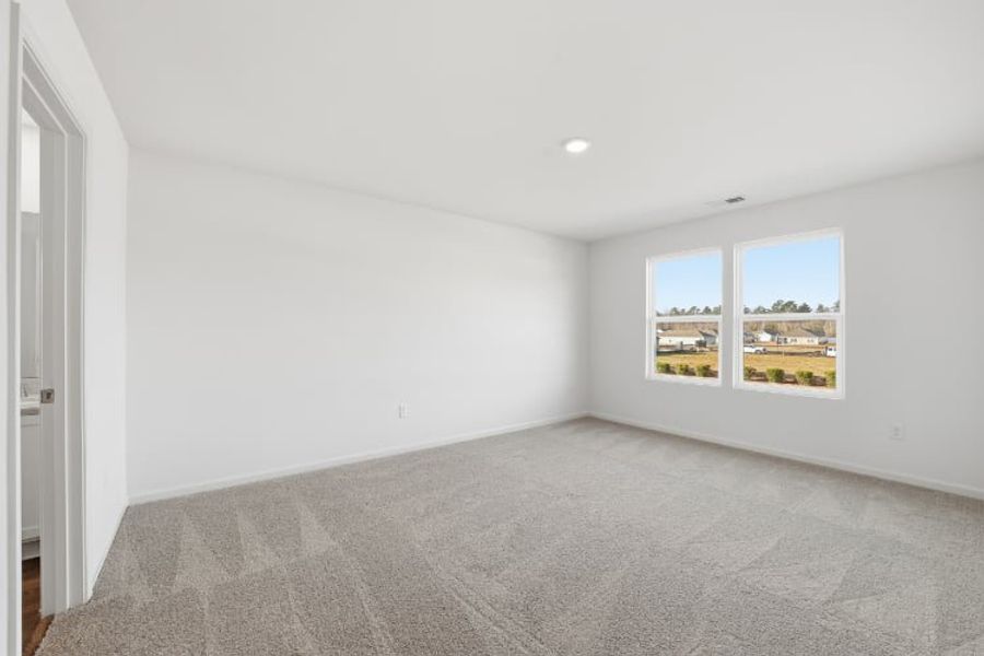 A room with a carpet and a window. A room with a carpet and a window.