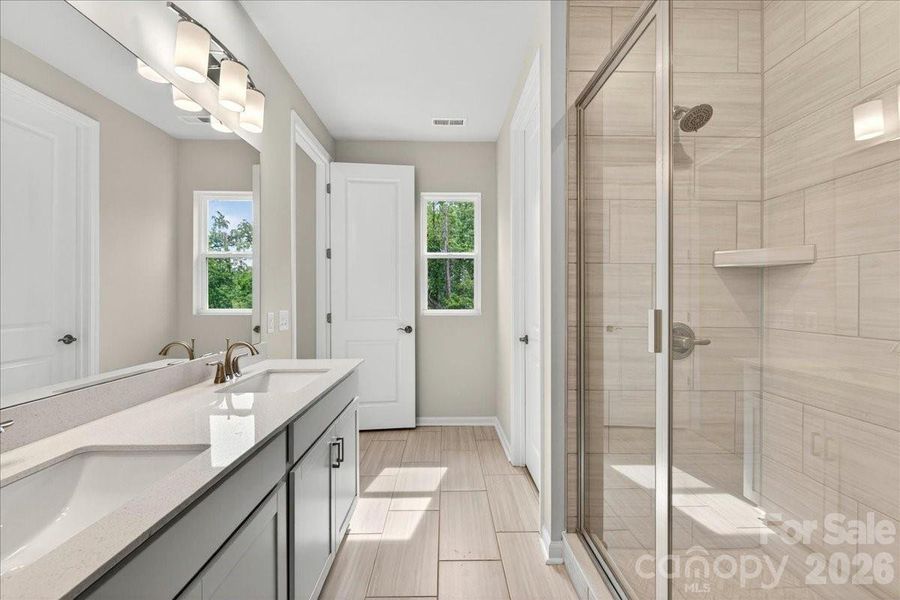 Light filled bathroom with tree-lined views for added privacy Light filled bathroom with tree-lined views for added privacy