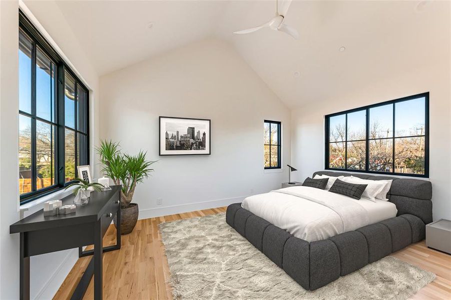 Bedroom with ceiling fan, high vaulted ceiling, and light hardwood / wood-style flooring