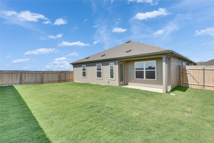 Rear view of property with a shingled roof and a patio