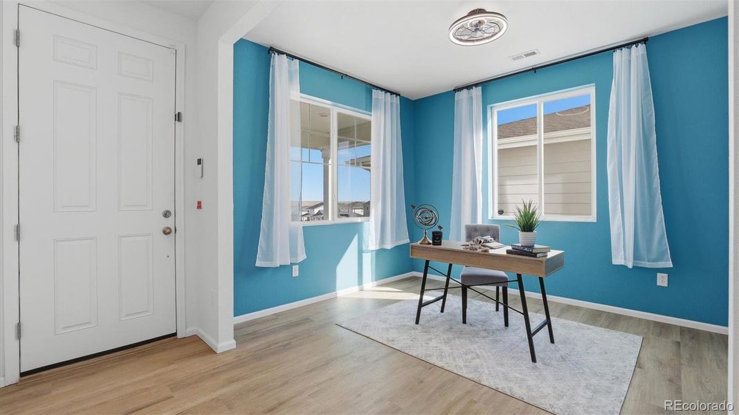 Upon entry, you’re welcomed by a versatile home office or sitting area with LVP flooring and windows that provide lots of natural sunlight.