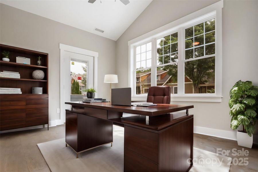 Virtually staged sunroom with vaulted ceiling.