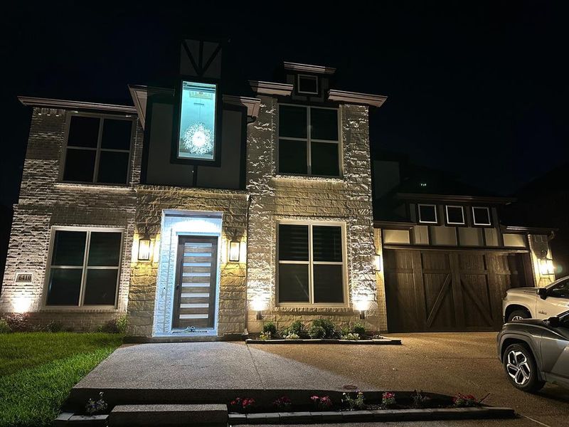 Modern home with a garage and brick siding