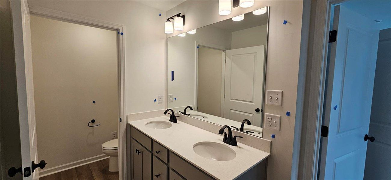 This bathroom features a double vanity with ample