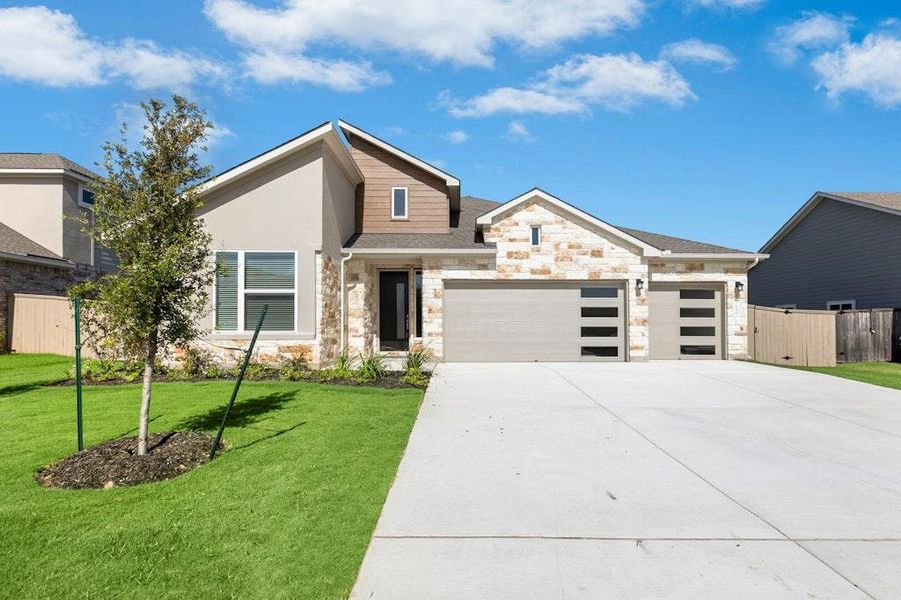Front exterior of a new home in The Colony, Bastrop, TX, highlighting curb appeal (Image 18).