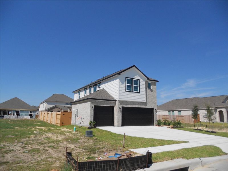 Front exterior of a new home in River Ranch, Dayton, TX, highlighting curb appeal (Image 23).