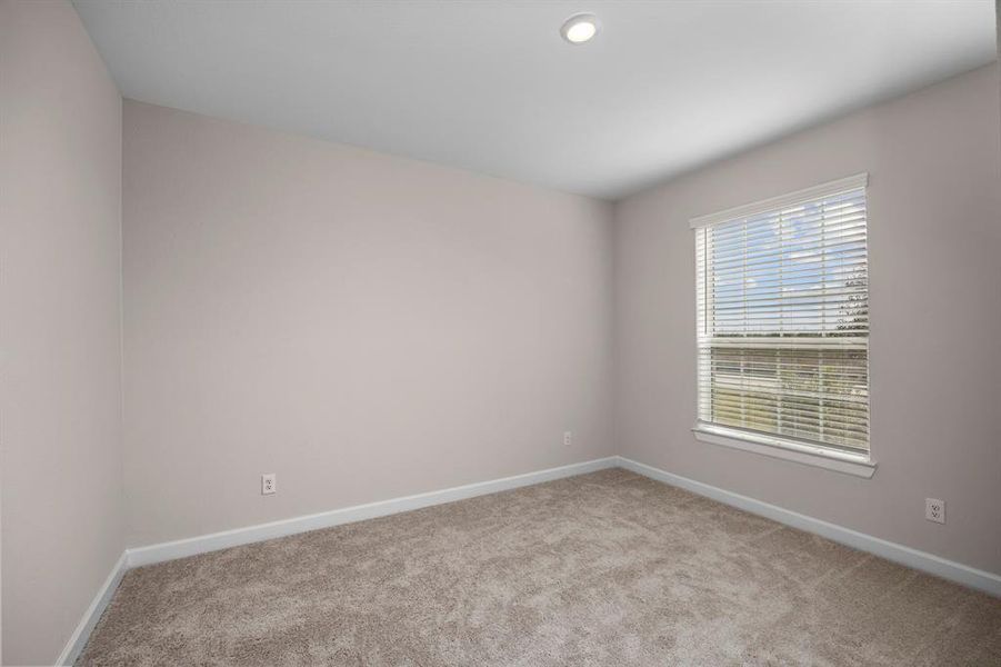 One of the three spacious secondary bedrooms