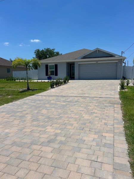 Front exterior of a new home in , Cape Coral, FL, highlighting curb appeal (Image 1). Front exterior of a new home in , Cape Coral, FL, highlighting curb appeal (Image 1).