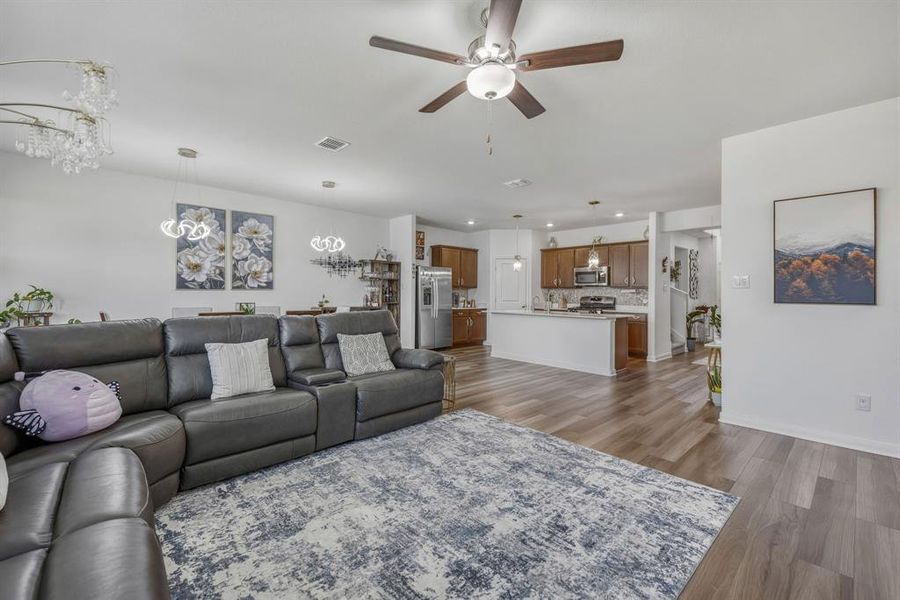 Open-concept living space featuring wood-finish flooring, recessed lighting, and a ceiling fan Open-concept living space featuring wood-finish flooring, recessed lighting, and a ceiling fan