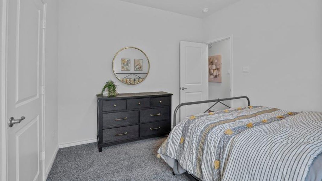 Bedroom with carpet flooring and baseboards