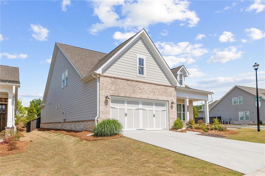 Front exterior of a new home in Courtyards at Traditions, Cumming, GA, highlighting curb appeal (Image 21).